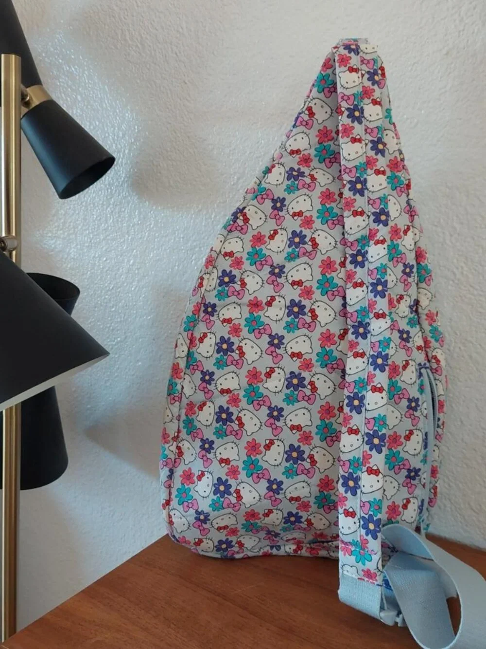 vera bradley Hello Kitty sling bag with repeating Hello Kitty faces and flowers